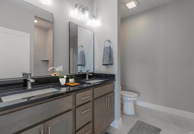 bathroom with vanity, toilet, and tile patterned flooring