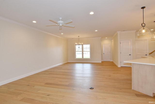 unfurnished room with ornamental molding, light hardwood / wood-style flooring, and ceiling fan with notable chandelier