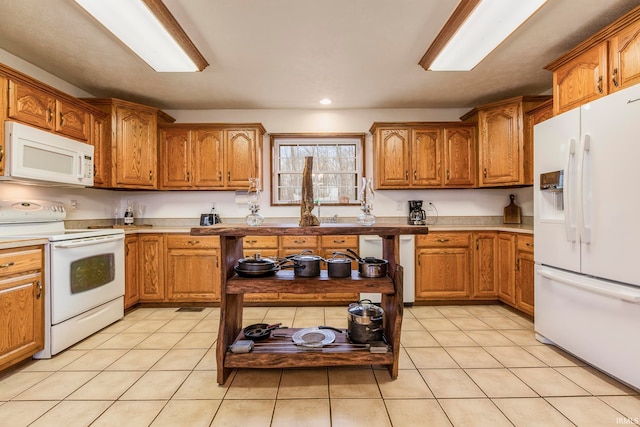 kitchen with white appliances and light tile floors