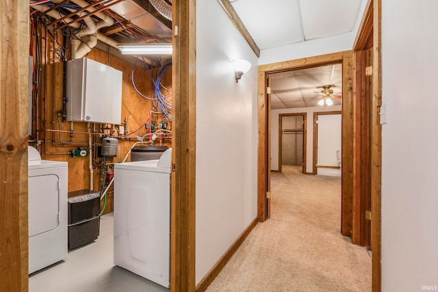 laundry room with cabinets, light carpet, water heater, and ceiling fan