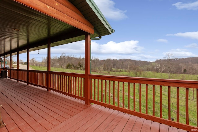 wooden terrace featuring a lawn