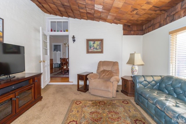 living room featuring vaulted ceiling and light colored carpet