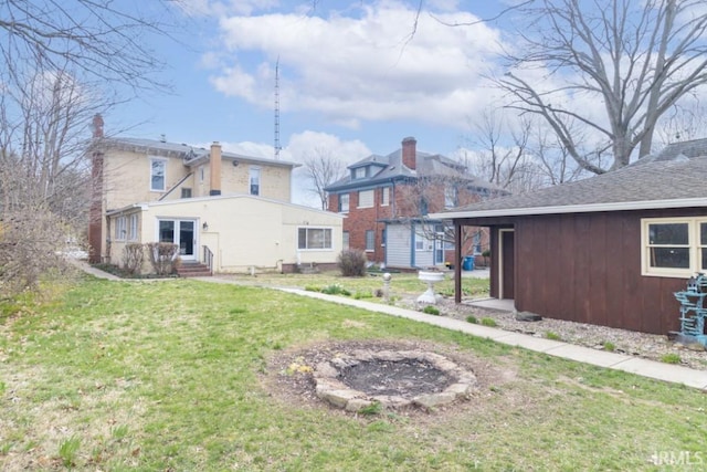 rear view of house featuring a lawn