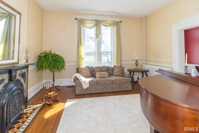 living room with hardwood / wood-style floors and radiator