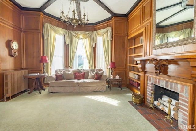 sitting room featuring radiator heating unit, a fireplace, dark carpet, and an inviting chandelier