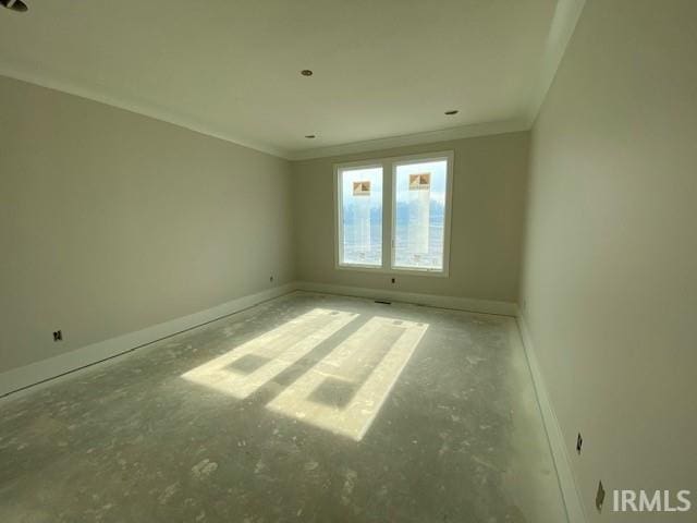 empty room featuring crown molding