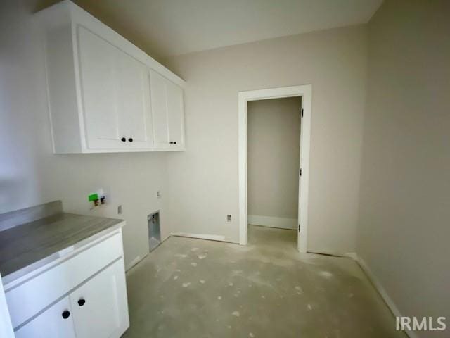 clothes washing area with cabinets, washer hookup, and electric dryer hookup