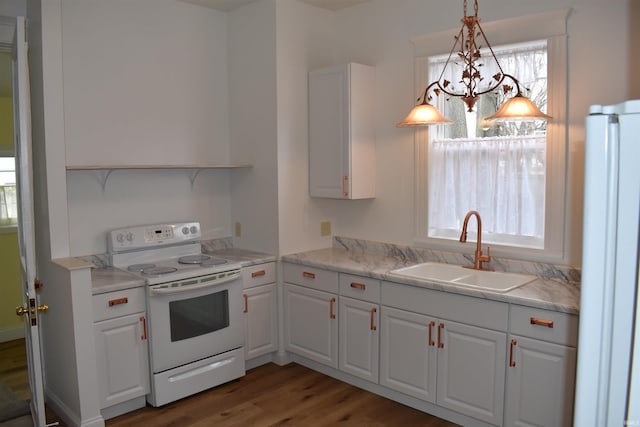 kitchen featuring pendant lighting, sink, white appliances, and white cabinetry