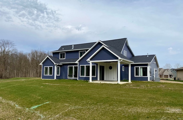 view of front of home with central air condition unit and a front lawn