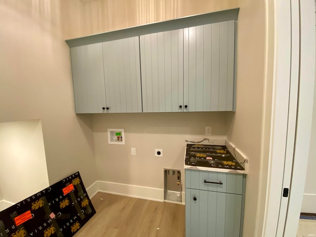 clothes washing area featuring electric dryer hookup, cabinets, light wood-type flooring, and hookup for a washing machine