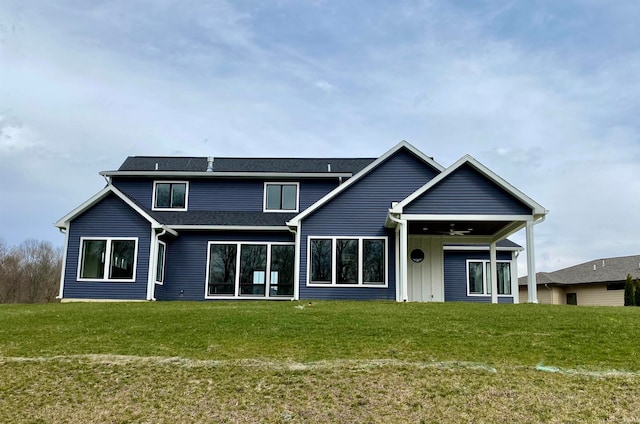 exterior space with ceiling fan and a lawn