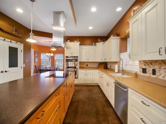 kitchen featuring a chandelier, appliances with stainless steel finishes, hanging light fixtures, island exhaust hood, and sink