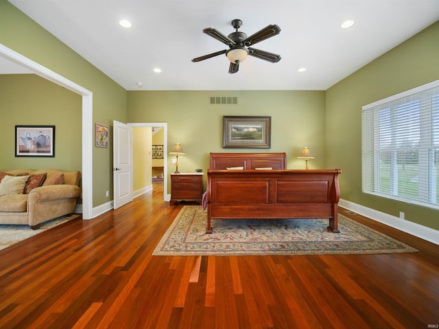 bedroom with ceiling fan and dark wood-type flooring