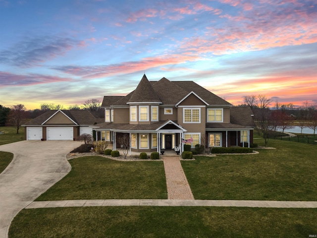 view of front facade featuring a porch, a garage, and a lawn