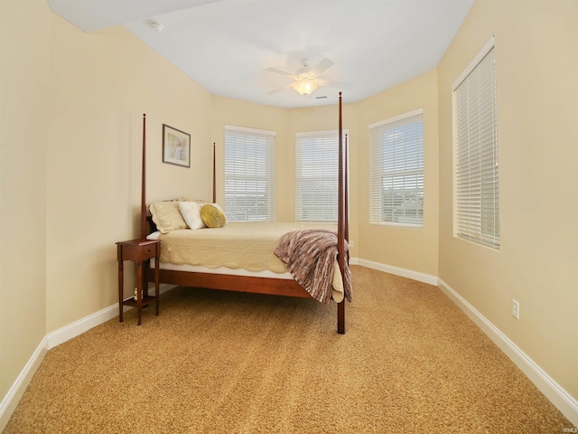 bedroom with ceiling fan and light colored carpet