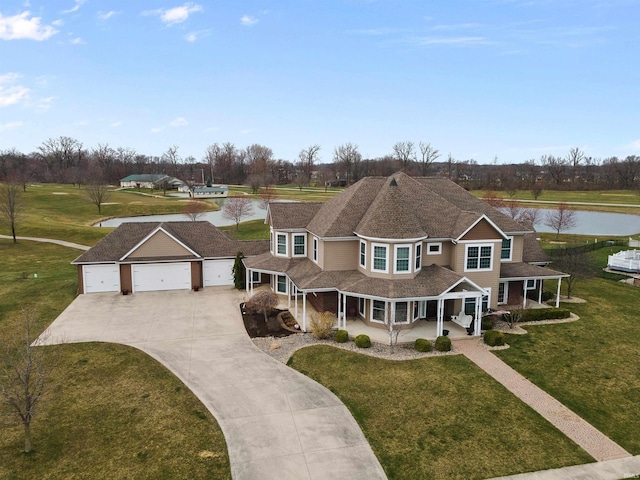 view of front facade with a front yard, a porch, and a garage