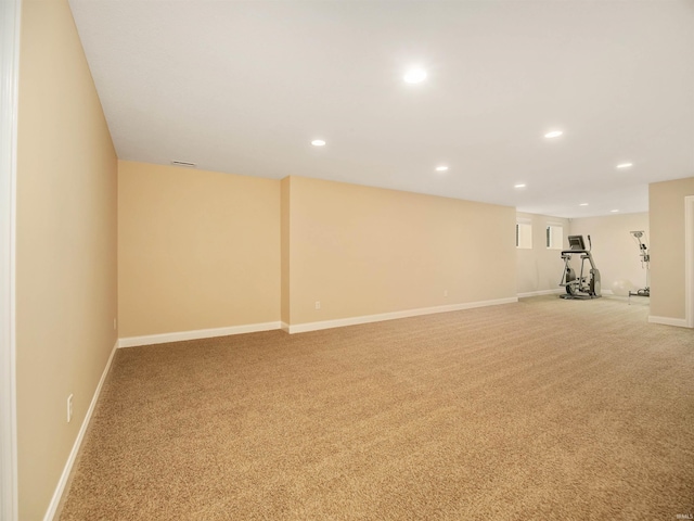 basement featuring light colored carpet