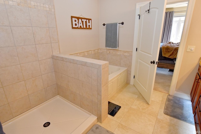 bathroom with tile flooring and tiled tub