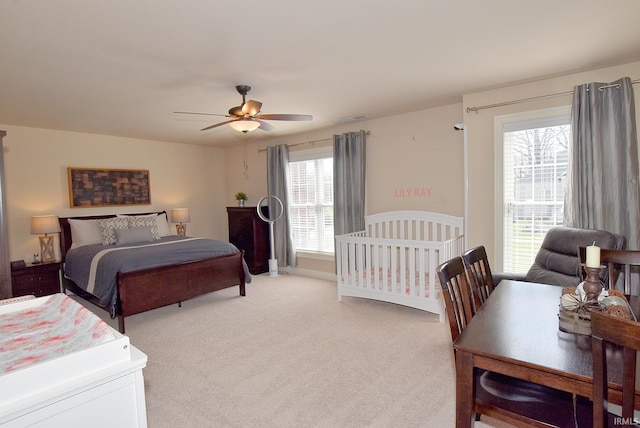 bedroom with light carpet and ceiling fan