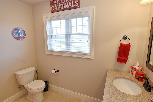 bathroom featuring tile flooring, toilet, and vanity