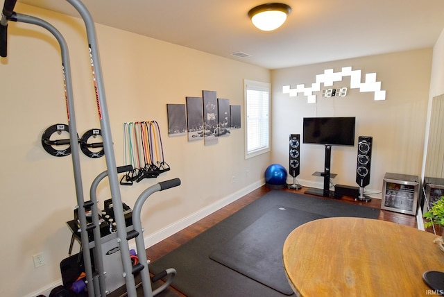 exercise room featuring dark hardwood / wood-style floors