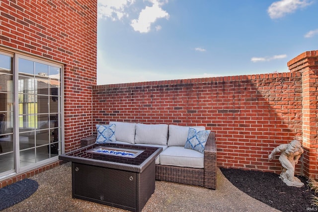 view of patio with an outdoor living space with a fire pit