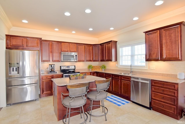 kitchen featuring light stone countertops, a kitchen breakfast bar, appliances with stainless steel finishes, light tile floors, and crown molding