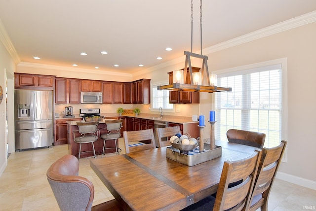 tiled dining area with crown molding, sink, and a wealth of natural light