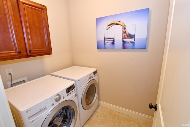 clothes washing area with cabinets, separate washer and dryer, light tile floors, and hookup for a washing machine