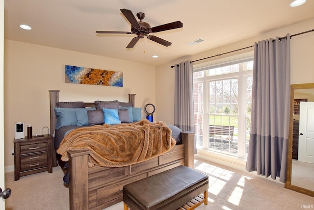 bedroom featuring ceiling fan and light colored carpet