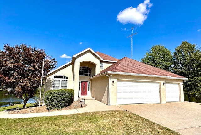 view of front of property with a front yard and a garage