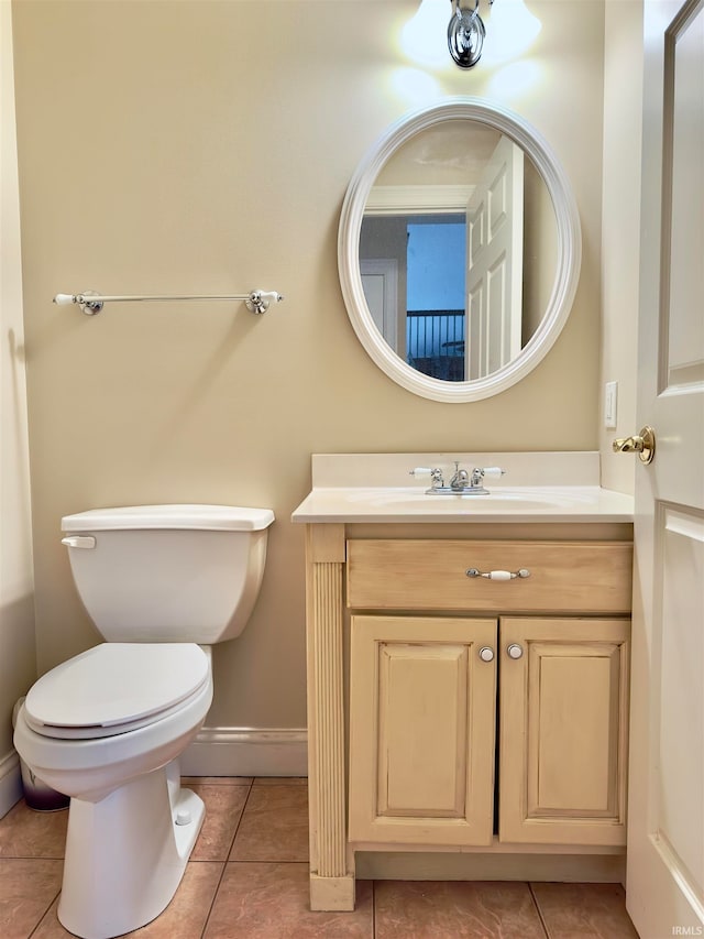 bathroom featuring tile floors, toilet, and vanity