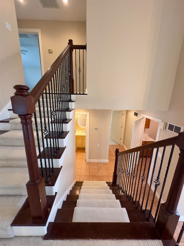 stairway featuring tile floors