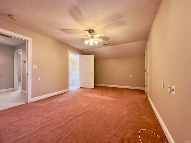 additional living space with light carpet, a textured ceiling, and ceiling fan