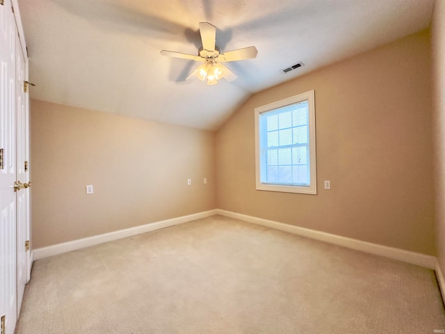 additional living space with ceiling fan, light carpet, and vaulted ceiling