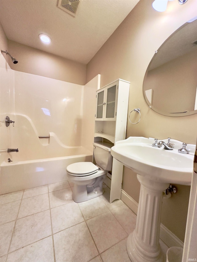 bathroom featuring a textured ceiling, toilet, tile floors, and shower / tub combination