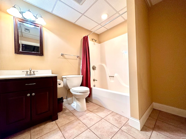 full bathroom featuring vanity, shower / bath combo with shower curtain, tile floors, a paneled ceiling, and toilet