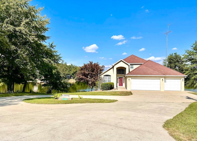 view of front of property with a front yard and a garage