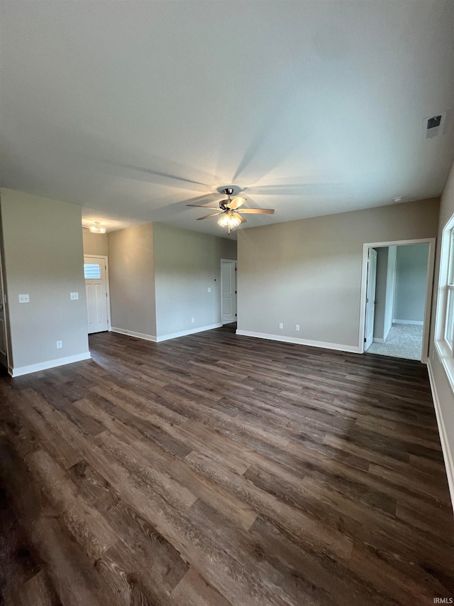 unfurnished living room featuring ceiling fan and dark hardwood / wood-style flooring