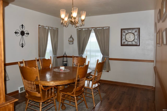 dining room with a notable chandelier and dark hardwood / wood-style floors