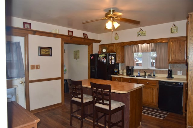 kitchen with ceiling fan, sink, dark hardwood / wood-style flooring, decorative backsplash, and black appliances