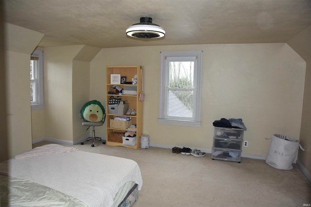 carpeted bedroom featuring lofted ceiling