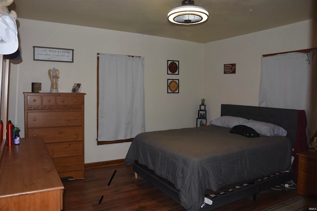 bedroom with dark wood-type flooring