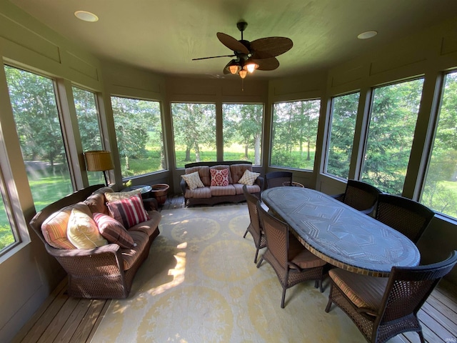 sunroom with plenty of natural light and ceiling fan