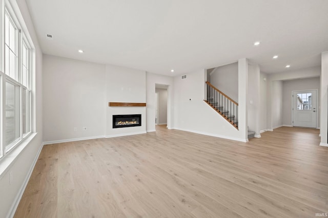 unfurnished living room with light wood-type flooring