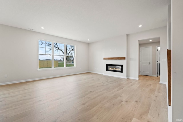 unfurnished living room with light wood-type flooring