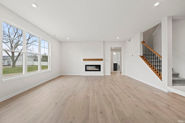 unfurnished living room featuring light wood-type flooring