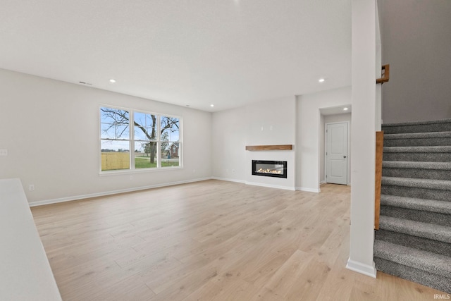 unfurnished living room with light wood-type flooring