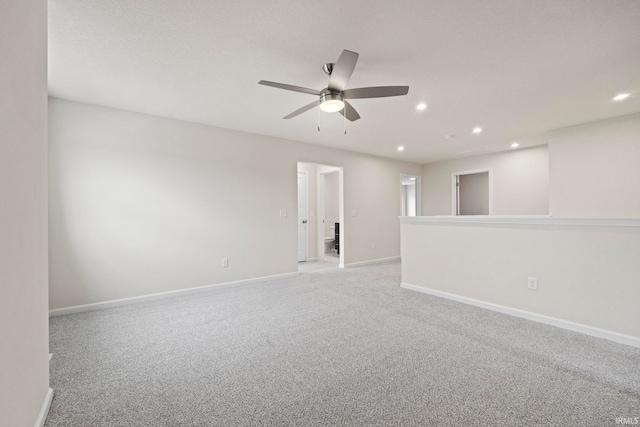 unfurnished room with light colored carpet and ceiling fan