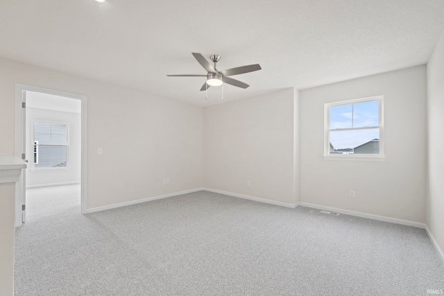 unfurnished room featuring ceiling fan and light carpet